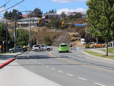 Image of people biking and driving along Watkiss Way and Burnside Road W