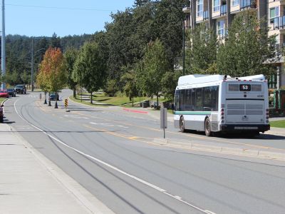 Image of a bus driving along Watkiss Way